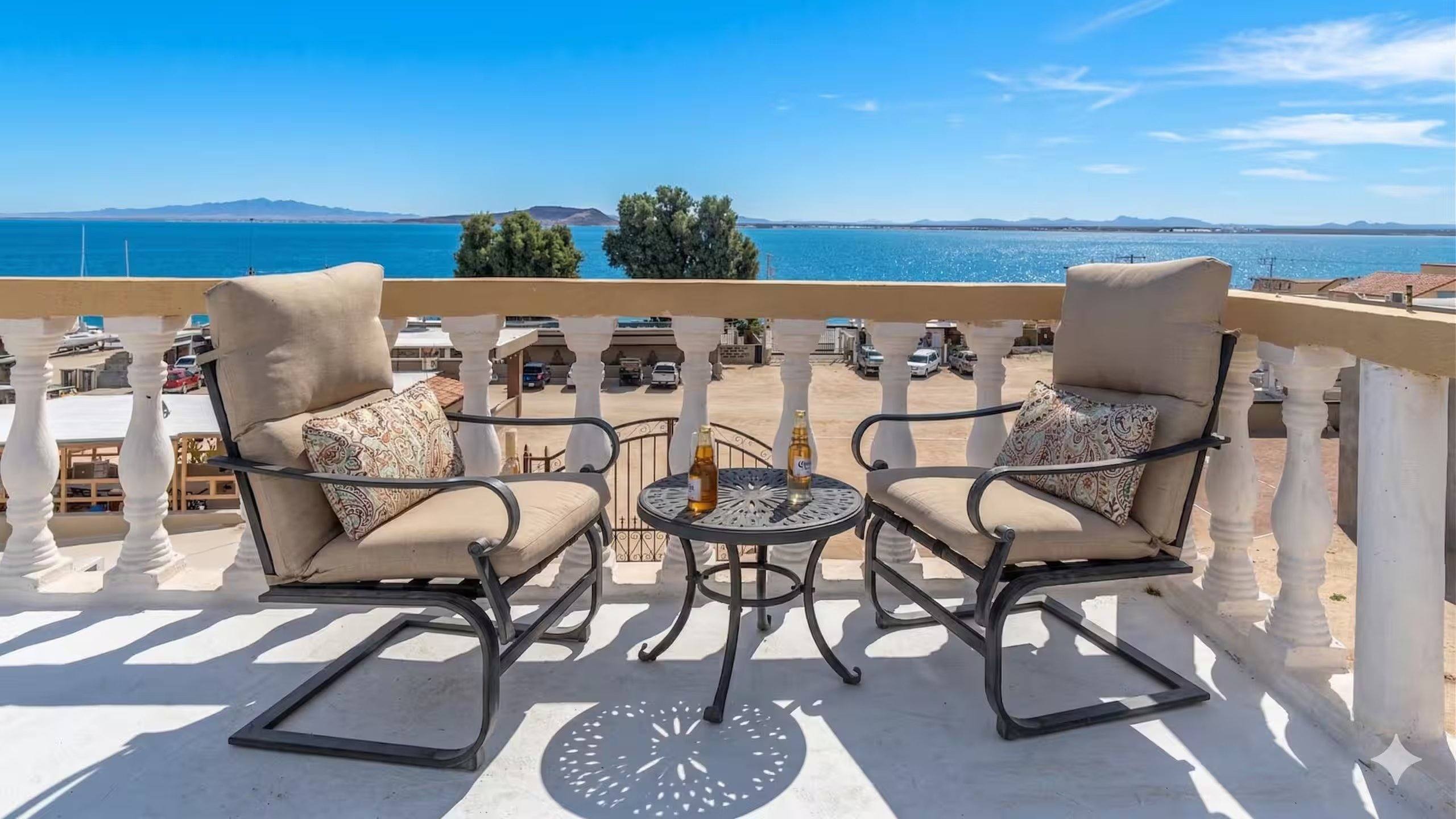 Two patio chairs and a small table on the Cholla Bay Vista balcony facing the ocean