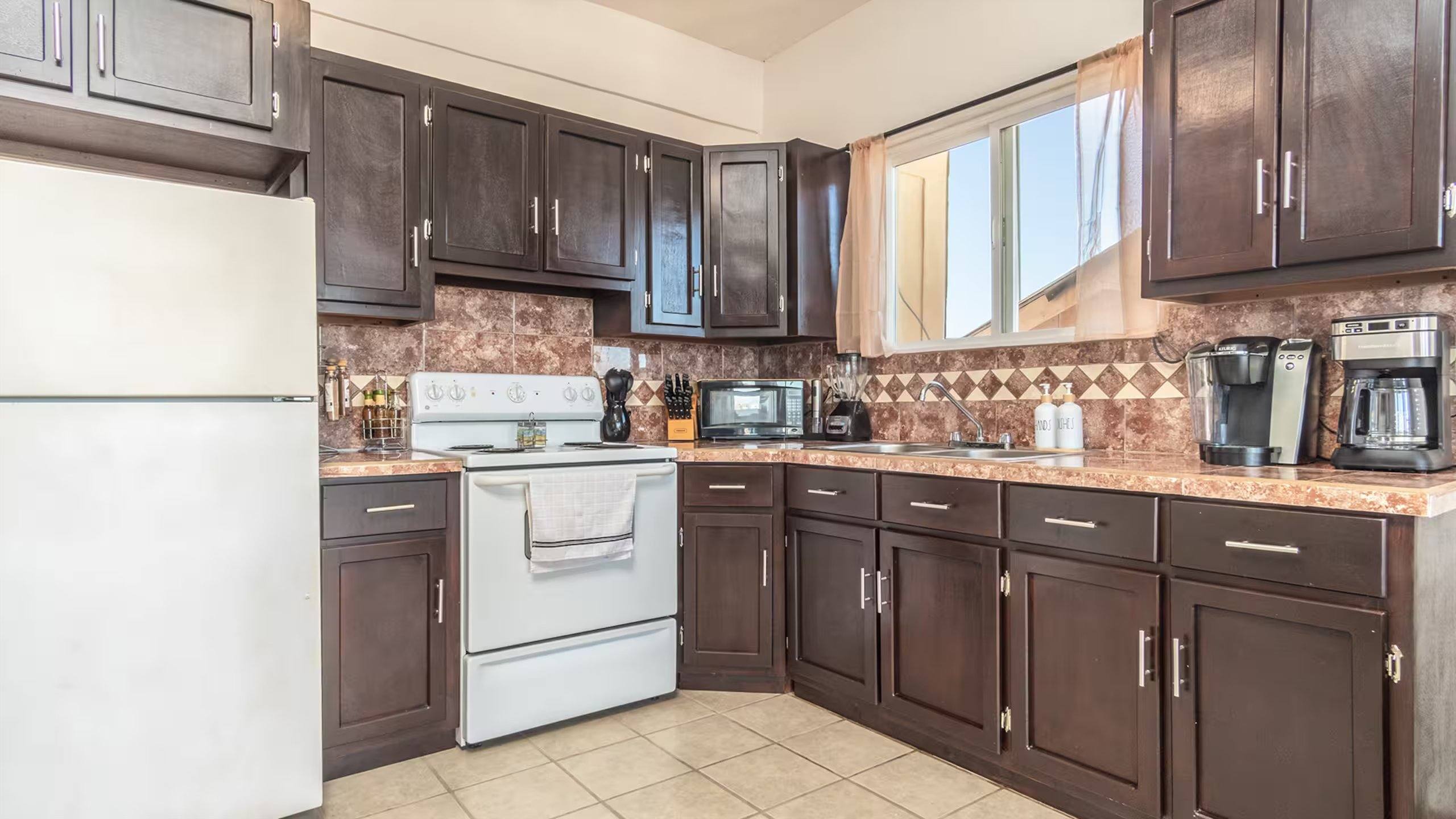 Fully equipped kitchen at Cholla Bay Vista with a full-size fridge, range, and coffee makers