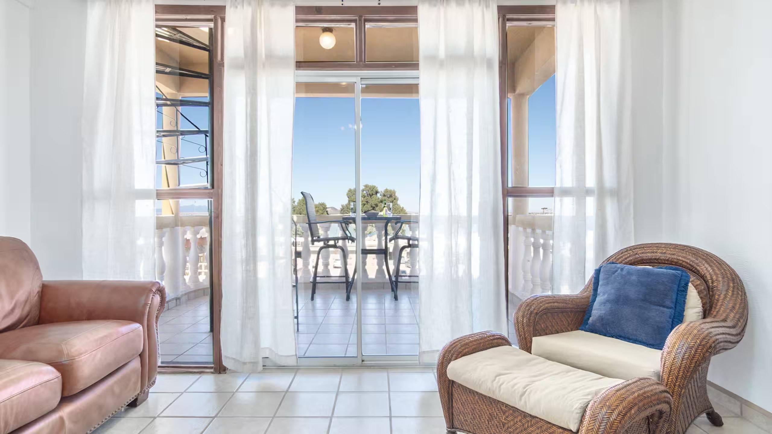 Living room at Cholla Bay Vista with leather seating and glass doors open to the balcony