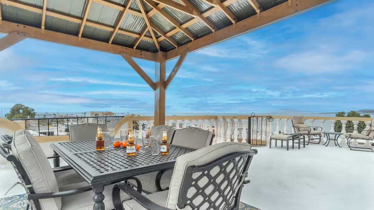 Shaded rooftop dining table under the palapa at Cholla Bay Vista with the Sea of Cortez beyond