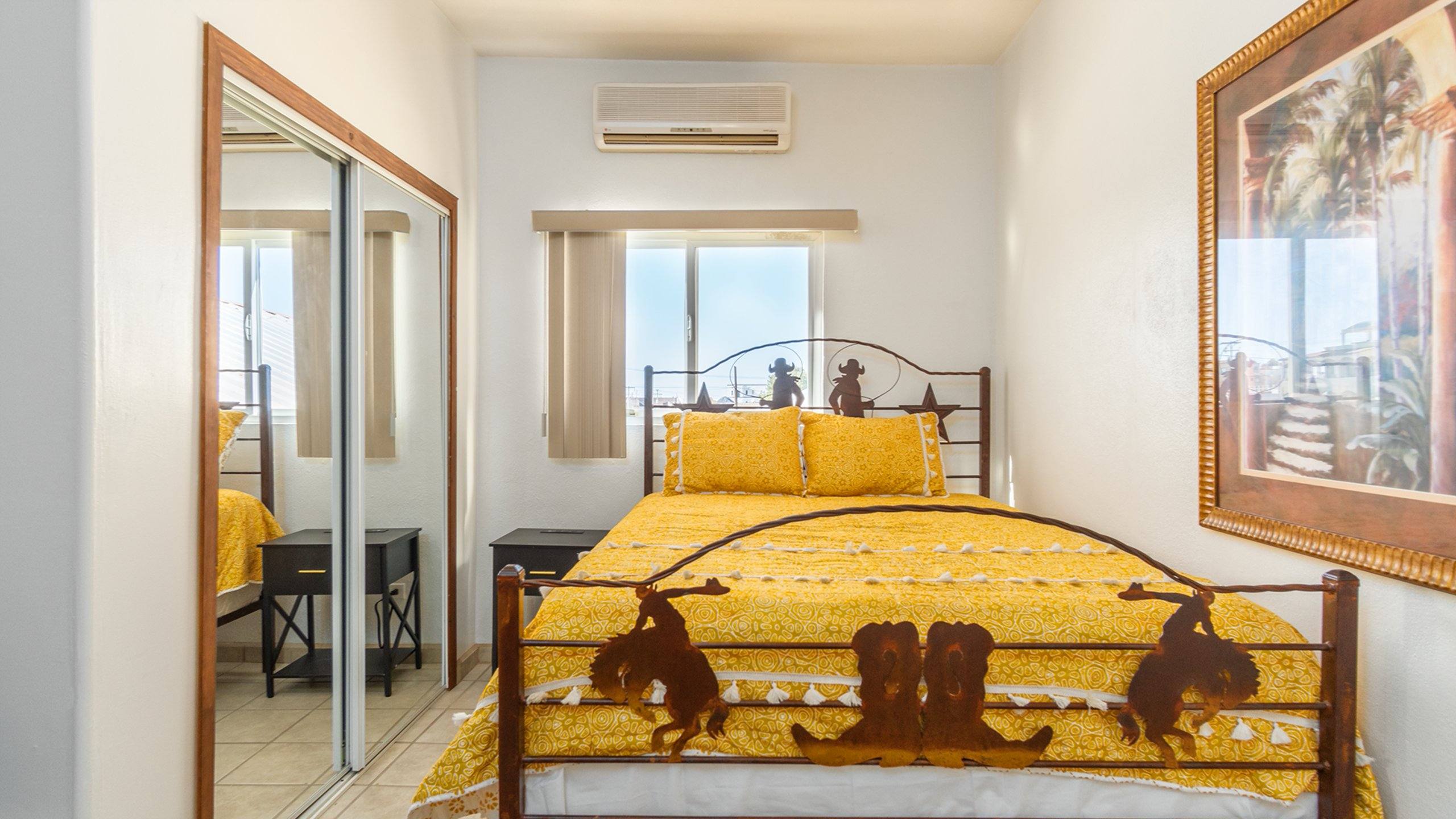 Second bedroom at Cholla Bay Vista with a western-style queen bed and a mirrored closet
